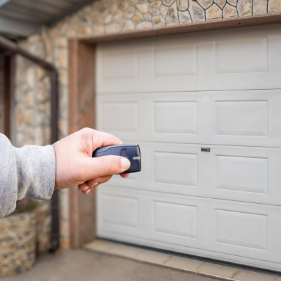 Omaha security key fob pointing to a garage door